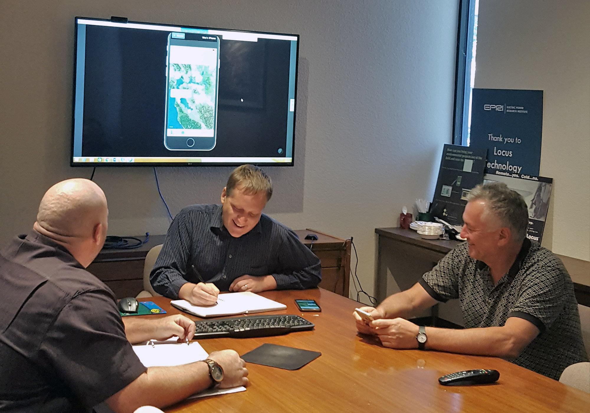 Locus employees, Wes, and Neno discussing new mobile app tools